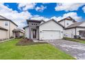 Beautiful single Gathering home with a two car garage and landscaped front yard at 7848 Somersworth Dr, Kissimmee, FL 34747