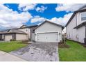 Charming single-Gathering home featuring a 2-car garage and beautifully manicured lawn at 7848 Somersworth Dr, Kissimmee, FL 34747