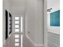 Bright foyer with tile flooring, a modern front door, and a view into the adjacent room at 7921 Jacks Club Dr, Kissimmee, FL 34747