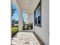 Inviting covered porch with a brick paver floor, perfect for enjoying the outdoors at 7921 Jacks Club Dr, Kissimmee, FL 34747