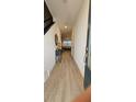 Inviting entryway featuring wood-look tile flooring, decor, and a glimpse into the living area at 803 Longboat Dr, Davenport, FL 33896