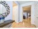 Spacious foyer showcasing tile floors, a decorative mirror, and an open floor plan at 8908 Adriatico Ln, Kissimmee, FL 34747
