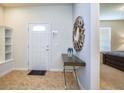Welcoming foyer with tile flooring, console table, decorative mirror, and built-in shelving at 8908 Adriatico Ln, Kissimmee, FL 34747