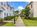 Charming community street view showcasing well-manicured lawns, sidewalks, and beautifully maintained townhomes at 8982 Shine Drive, Kissimmee, FL 34747