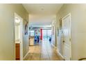 Inviting hallway with tile flooring, connecting to the living area with a view of the pool at 9156 Wedge Dr, Davenport, FL 33896