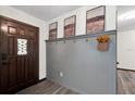 Home entryway featuring a stylish coat rack and a wooden front door with decorative glass at 621 Avocado St, St Cloud, FL 34769