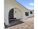 Welcoming front entrance with an arched doorway and a brick-paved patio leading to the front door at 621 Avocado St, St Cloud, FL 34769