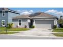 Well-maintained home with a manicured lawn, two-car garage, and solar panels at 1228 Haines Dr, Winter Haven, FL 33881