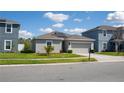 Charming single-Gathering home featuring a manicured lawn and a two-car garage at 1228 Haines Dr, Winter Haven, FL 33881