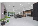 Bright, open-concept living space featuring sleek tile flooring, modern furnishings, and natural light at 13049 Sunshine Cir, Clermont, FL 34711