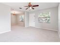 Spacious living room with neutral carpeting, windows, and good natural light at 1418 Delaware Ave, St Cloud, FL 34769