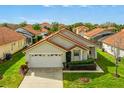 Attractive single-Gathering home with a well-manicured lawn and a red-tiled roof at 151 Saragossa Ave, Davenport, FL 33897