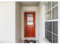 Elegant front door with decorative glass panel and a floral door mat at 151 Saragossa Ave, Davenport, FL 33897