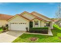 Charming single-Gathering home showcasing a well-manicured front lawn and attached two-car garage at 151 Saragossa Ave, Davenport, FL 33897