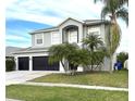 Charming two-story home with a three-car garage and a well maintained lawn at 1713 Brassie Ct, Kissimmee, FL 34746