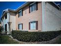 Two-story townhouse showcasing charming shutters and well-maintained landscaping at 175N Pearl Lake Cswy # 114, Altamonte Springs, FL 32714