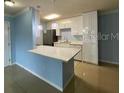Modern kitchen with a breakfast bar, stainless steel appliances, and ample counter space at 175N Pearl Lake Cswy # 114, Altamonte Springs, FL 32714