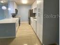 Updated kitchen featuring bright cabinetry, stainless steel appliances, and tile flooring at 175N Pearl Lake Cswy # 114, Altamonte Springs, FL 32714