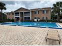 Community pool with blue tile and chaise lounge at 175N Pearl Lake Cswy # 114, Altamonte Springs, FL 32714