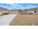 Inviting single-story home showcases a well-kept lawn, a spacious driveway and a two car attached garage at 251 Tower View W Dr, Haines City, FL 33844