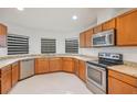 Bright kitchen features granite countertops, wooden cabinetry and stainless steel appliances at 251 Tower View W Dr, Haines City, FL 33844