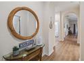 Inviting hallway with decorative mirror, glass table and hardwood floors leading to other rooms in the condo at 313 Lucaya Loop # 313, Davenport, FL 33897