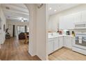Bright condo kitchen with white cabinets, modern appliances, and an open layout flowing into the living area at 313 Lucaya Loop # 313, Davenport, FL 33897