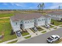 Spacious townhomes showcasing a well-kept exterior, individual driveways, and a beautifully landscaped community at 345 Sedgewick Dr, Davenport, FL 33837