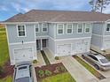 Inviting townhomes boast attached garages, manicured front yards, and a modern exterior design at 345 Sedgewick Dr, Davenport, FL 33837
