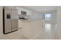 Bright kitchen featuring white cabinetry, stainless steel appliances, and a spacious center island at 345 Sedgewick Dr, Davenport, FL 33837