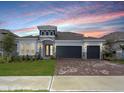 Beautiful one story home featuring a three-car garage, well-manicured lawn, and stone accents at 4507 Lions Gate Ave, Clermont, FL 34711
