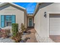 Inviting front entrance with a charming blue door, brick pathway, and manicured landscaping at 485 Disa Dr, Davenport, FL 33837