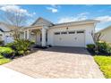 Inviting front exterior showcasing a paved driveway, well-maintained landscaping, and an attached two-car garage at 4918 Drawdy Ct, St Cloud, FL 34772