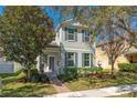 Charming two-story home with gray shutters, landscaping, and covered porch at 6054 Roseate Spoonbill Dr, Windermere, FL 34786