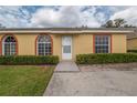 Charming single-story home featuring manicured front bushes and a welcoming walkway to the front door at 635 Lake Marion Golf Resort, Kissimmee, FL 34759