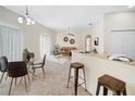 Open-concept living space features dining area, cozy seating, and neutral tones for a bright and airy feel at 7128 Red Lantern Dr # 0, Harmony, FL 34773