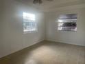 Bright, freshly painted room features tile flooring and natural light through two large windows at 736 Nw 31St Ct, Winter Haven, FL 33881