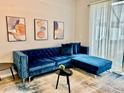 Modern living room featuring a stylish blue velvet sectional sofa at 7660 Otterspool St, Kissimmee, FL 34747