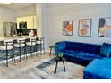 Open-concept living area with a kitchen island and comfortable seating at 7660 Otterspool St, Kissimmee, FL 34747