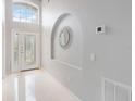 Bright foyer with tiled floors, high ceilings, and decorative mirror at 8122 Yellow Crane Dr, Kissimmee, FL 34747