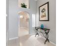 Inviting foyer with tile floors, neutral walls, arched entryway, and decorative lighting at 8122 Yellow Crane Dr, Kissimmee, FL 34747