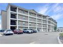 Multi-story apartment building showcasing a large exterior with multiple balconies and ample parking for residents at 841 Retreat Blvd # 101, Davenport, FL 33897