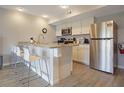 Bright kitchen featuring stainless steel appliances, granite countertops, and barstool seating at 841 Retreat Blvd # 101, Davenport, FL 33897