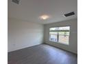 Cozy bedroom with plenty of natural light and modern floors for comfortable living at 9081 Oscraft Dr, Davenport, FL 33896
