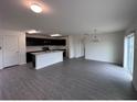 Open-concept living room and kitchen with modern flooring and plenty of space to spread out and relax at 9081 Oscraft Dr, Davenport, FL 33896