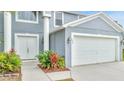 Charming home featuring a two-car garage, double door entry, and mature landscaping at 943 Van Loon Ct, Kissimmee, FL 34758