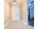 Inviting foyer with neutral walls, light tile floors, and a view into the living area at 133 Indian Wells Ave, Kissimmee, FL 34759