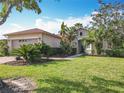 Charming single-story home with lush landscaping, mature trees, and a well-manicured lawn at 133 Indian Wells Ave, Kissimmee, FL 34759