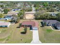 Single-Gathering home featuring a well-maintained lawn, fenced yard, long driveway, and a two-car garage at 15069 Sw 29Th Avenue Rd, Ocala, FL 34473