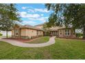 Spacious home with well-manicured lawn, stone accents, and a curved brick walkway leading to the front entrance at 1686 Shadowmoss Cir, Lake Mary, FL 32746